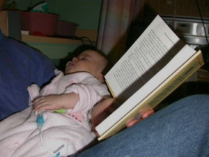 Father reading to baby with cancer