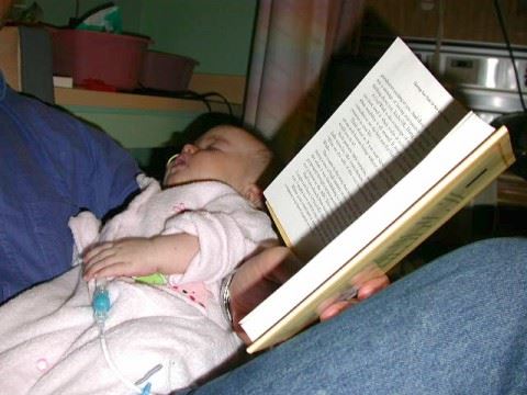 Steven Pecevich (father) reading to baby Sydni